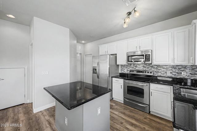 Full run of cabinetry with the range and microwave