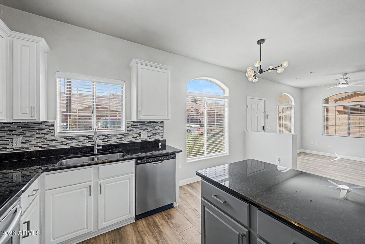 Updated kitchen with granite counters and stainless steel appliances