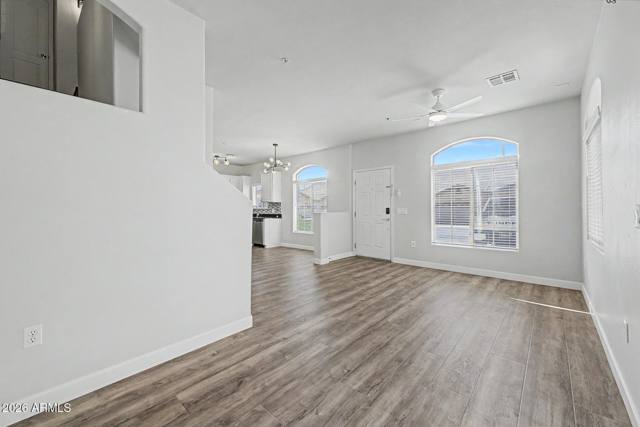 Living room with wood-look flooring and tall ceilings