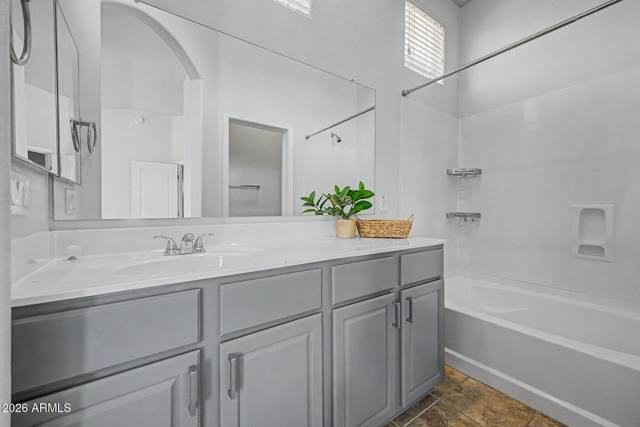 Primary bath with a long vanity and tub-shower