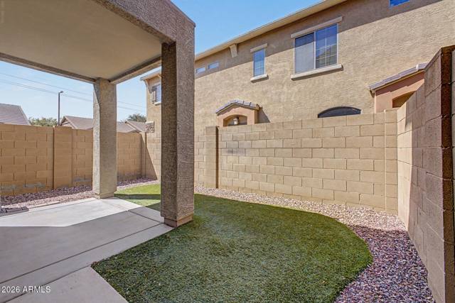 Easy-care turf and gravel, walled for privacy