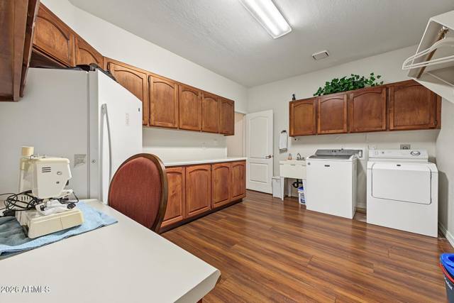 Laundry room with washer, dryer and cabinetry