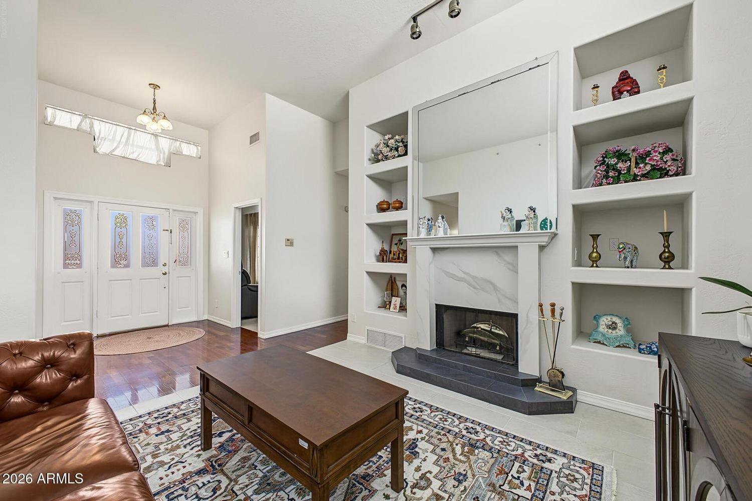 Formal living room with fireplace and white built-in shelves