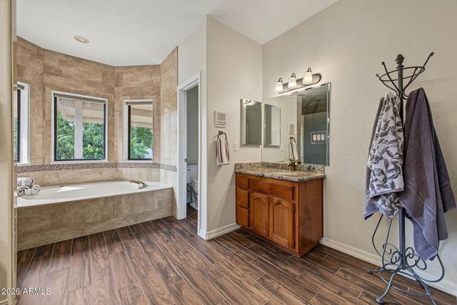 Soaking tub set into a bay window in the primary bath