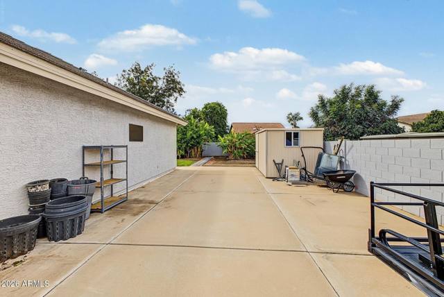 Concrete RV parking slab beside the house with storage shed