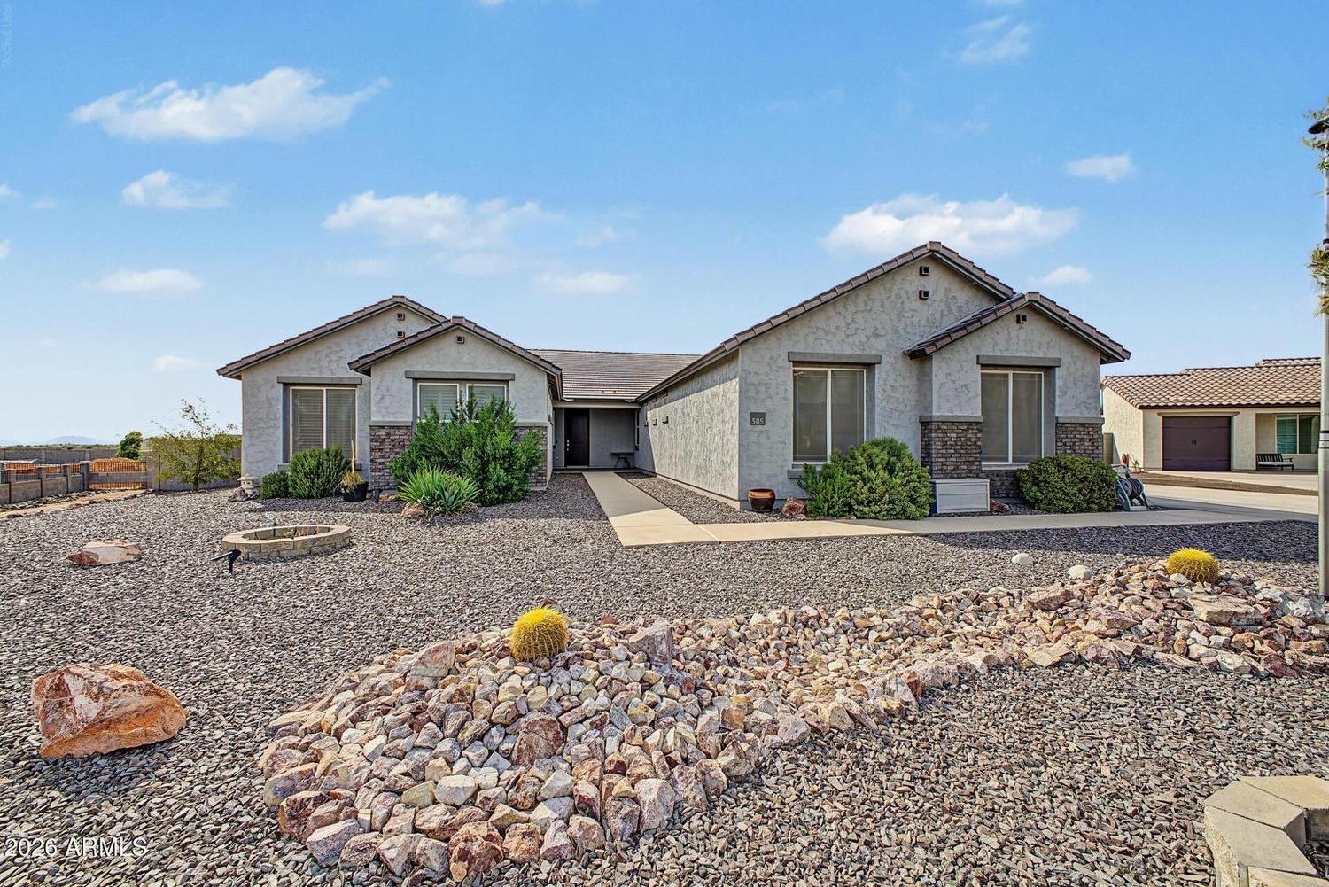 Front exterior of 505 W Amherst St, a single-story stucco home with tile roof and desert landscaping