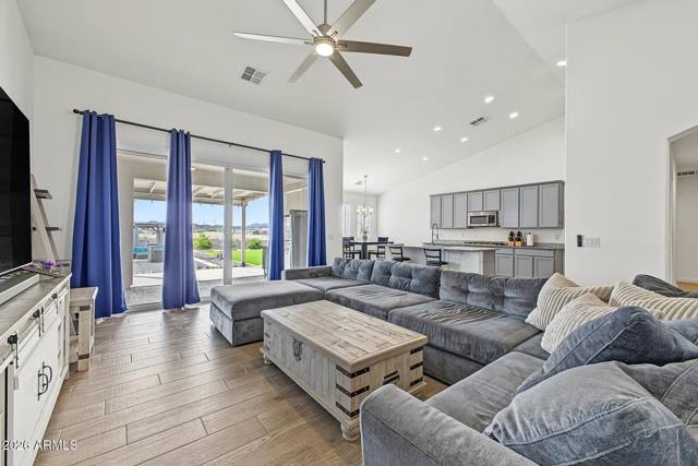 Great room with vaulted ceiling and sliding doors to the covered patio