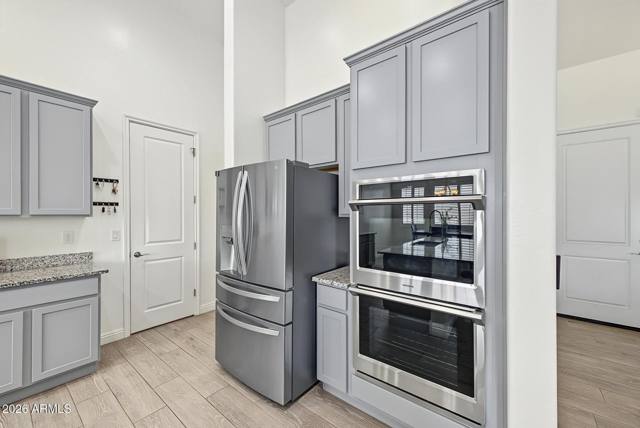 Stainless double wall ovens and refrigerator with pantry door