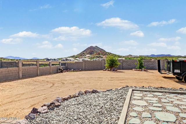 Rear yard with view fencing looking toward a desert peak