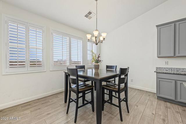 Eat-in kitchen nook with plantation shutters and chandelier