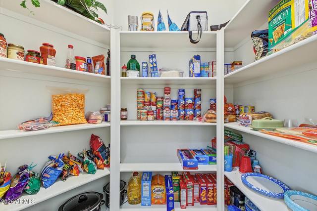 Walk-in pantry with white shelving