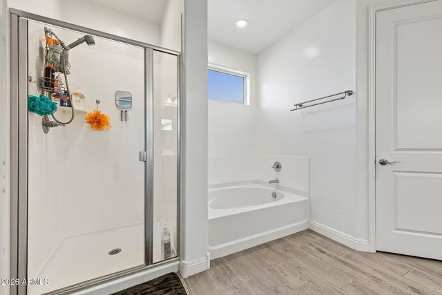 Primary bathroom with glass shower and soaking tub