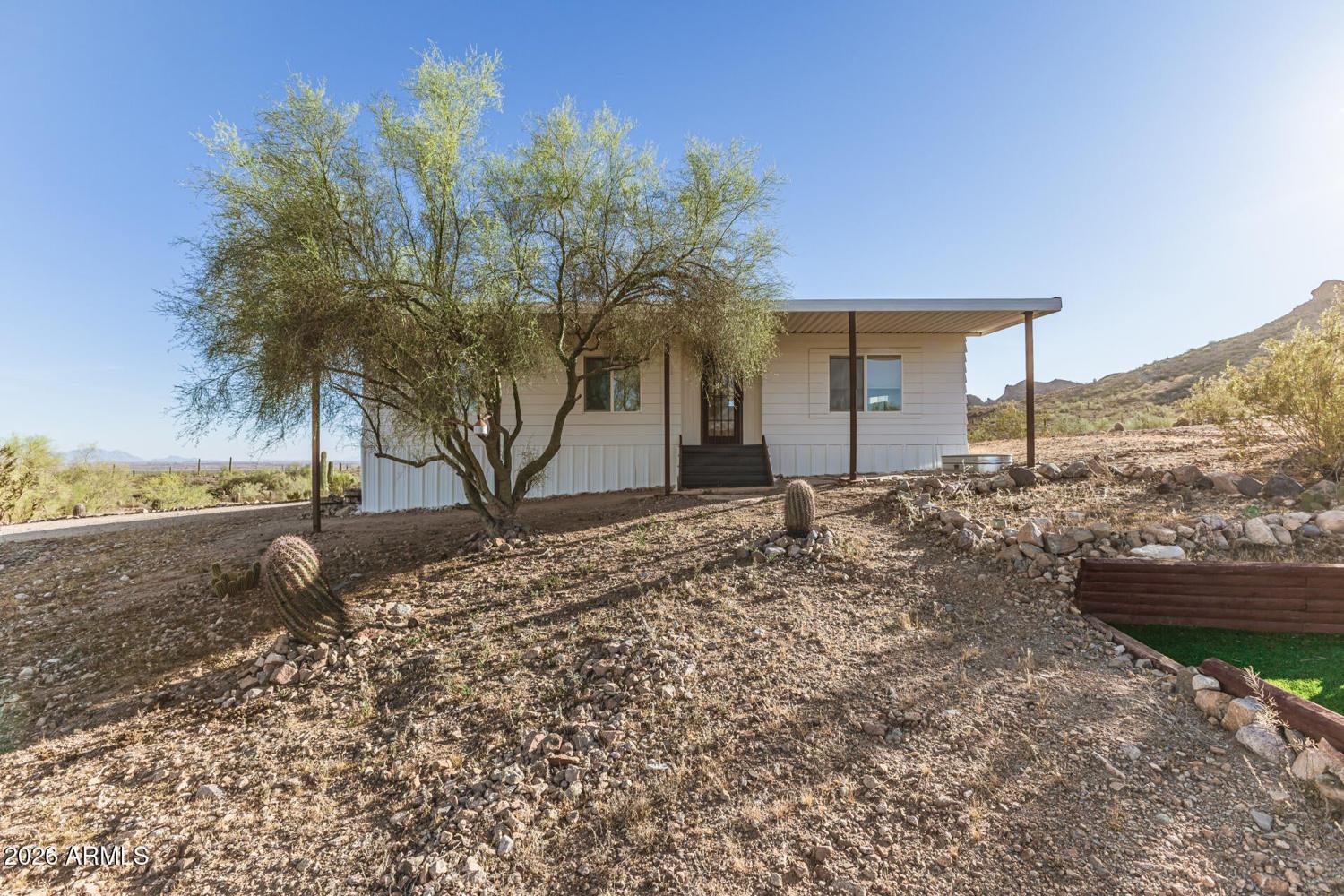 Detached guest house on the property with the desert butte behind it