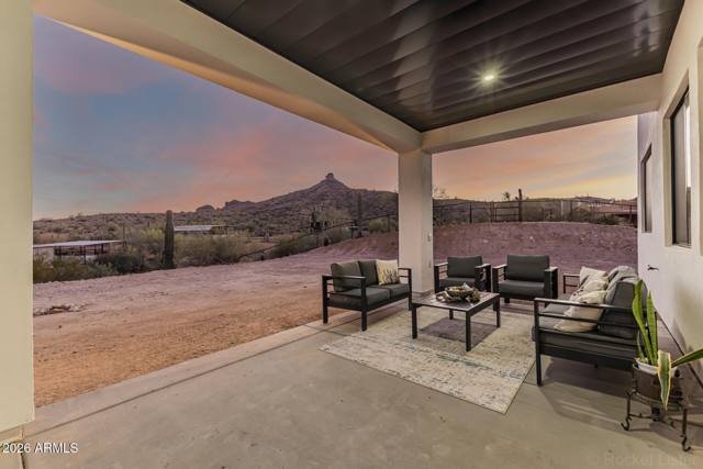 Covered patio at twilight looking out at the desert and butte