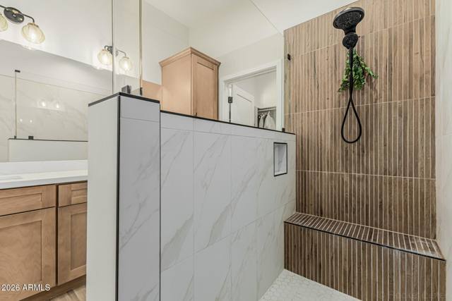 Separate shower and tub, with a bench and a rain head