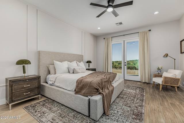 Primary bedroom with French doors opening to the covered patio