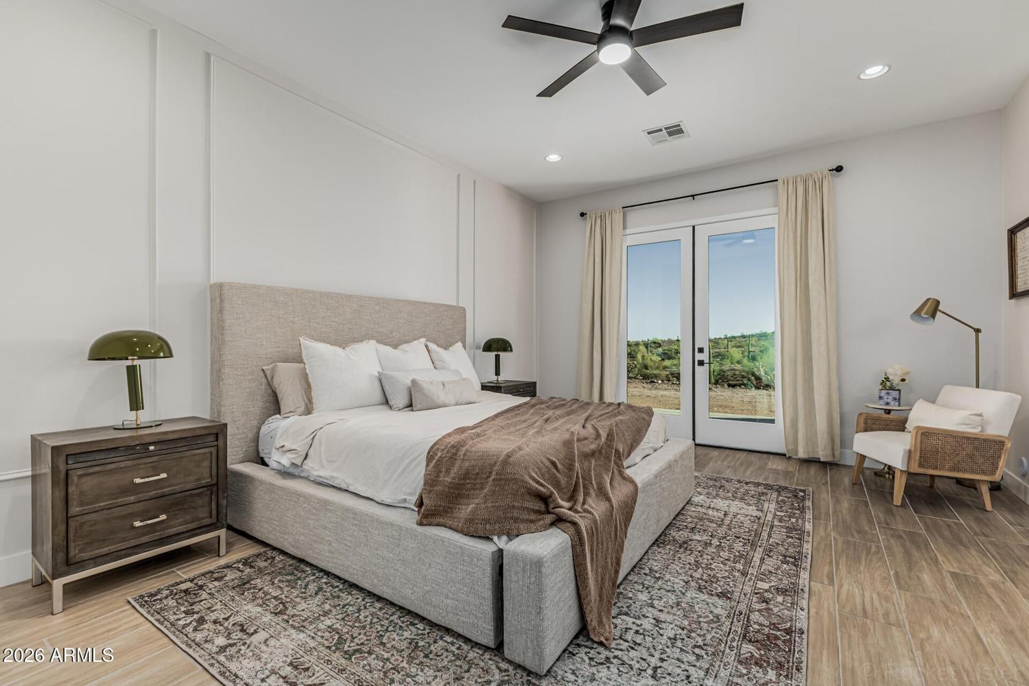 Primary bedroom with French doors opening to the covered patio
